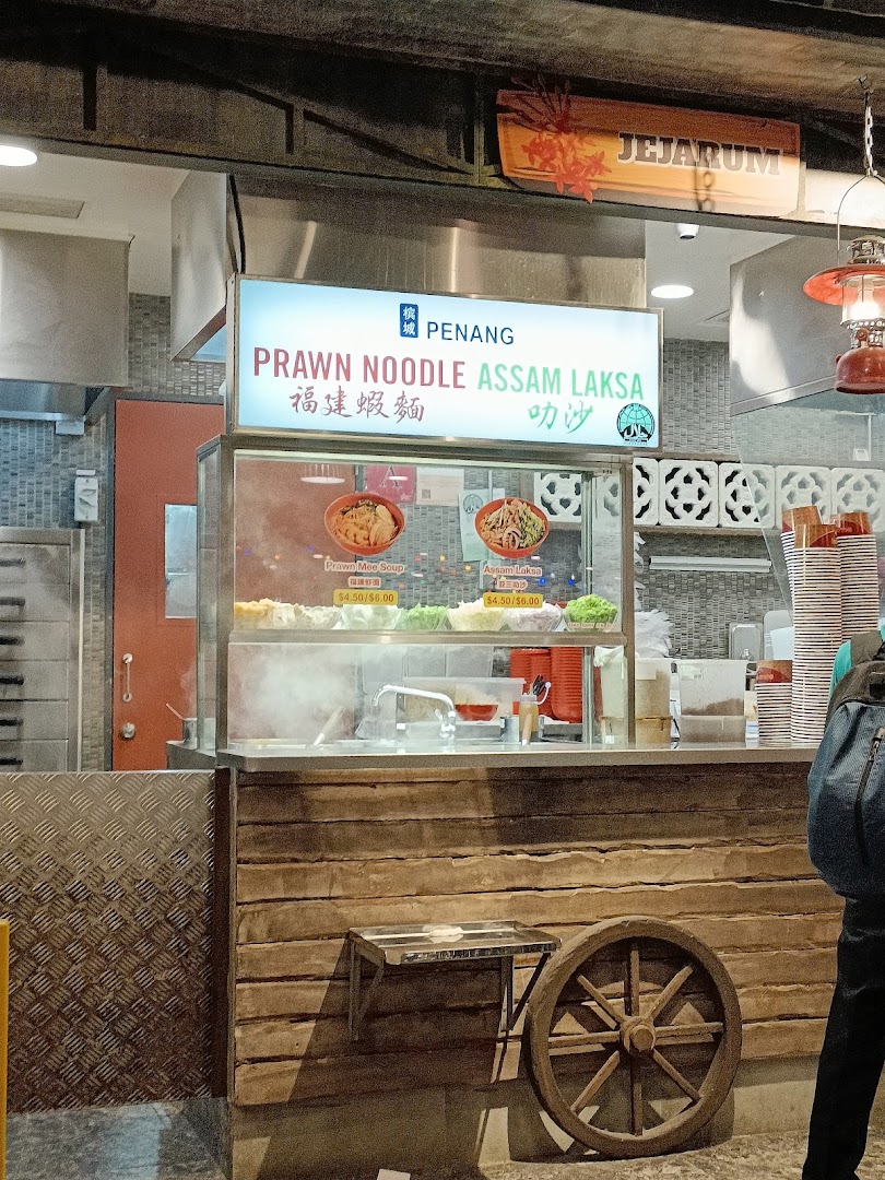A food stall counter at Boleh Boleh! Clementi Mall, featuring Penang Prawn Noodle and Assam Laksa.
