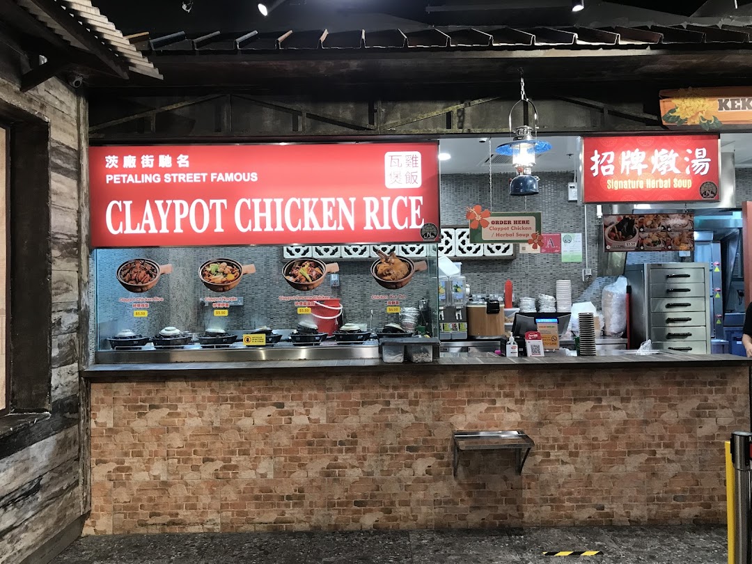 A food stall counter at Boleh Boleh! Clementi Mall, featuring Claypot Chicken Rice and Signature Herbal Soup.