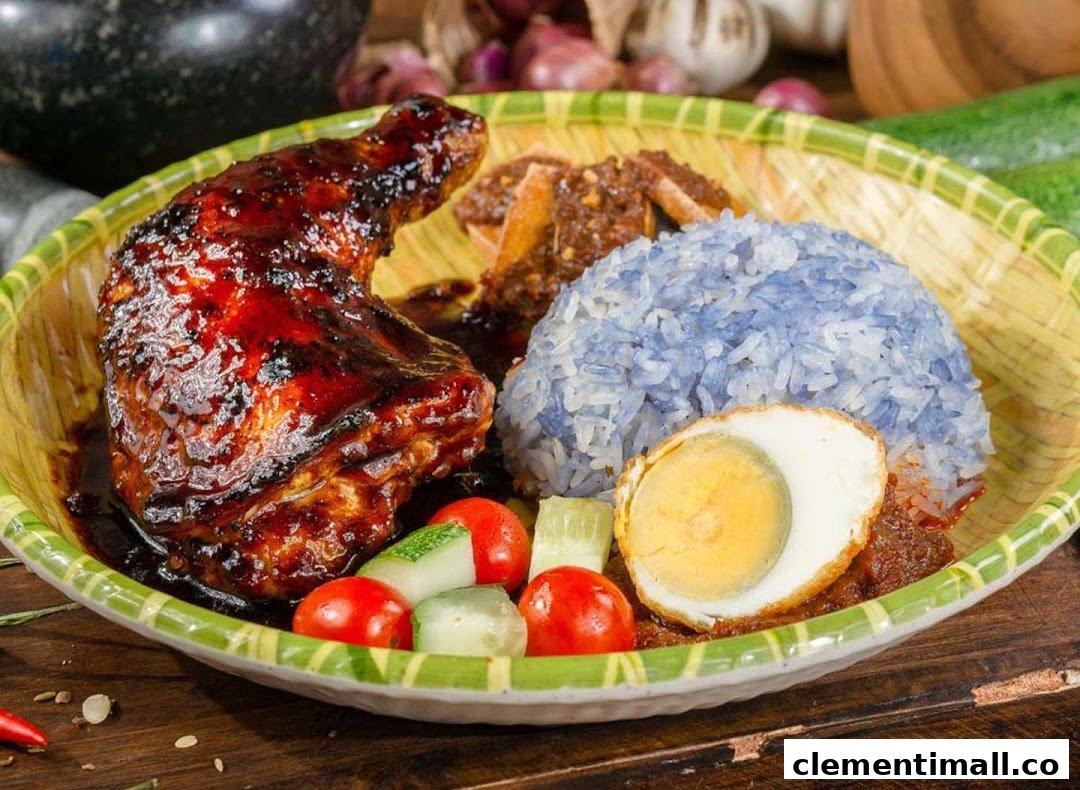 A vibrant plate of Nasi Lemak featuring a glazed chicken leg, blue pea rice, and a fried egg.