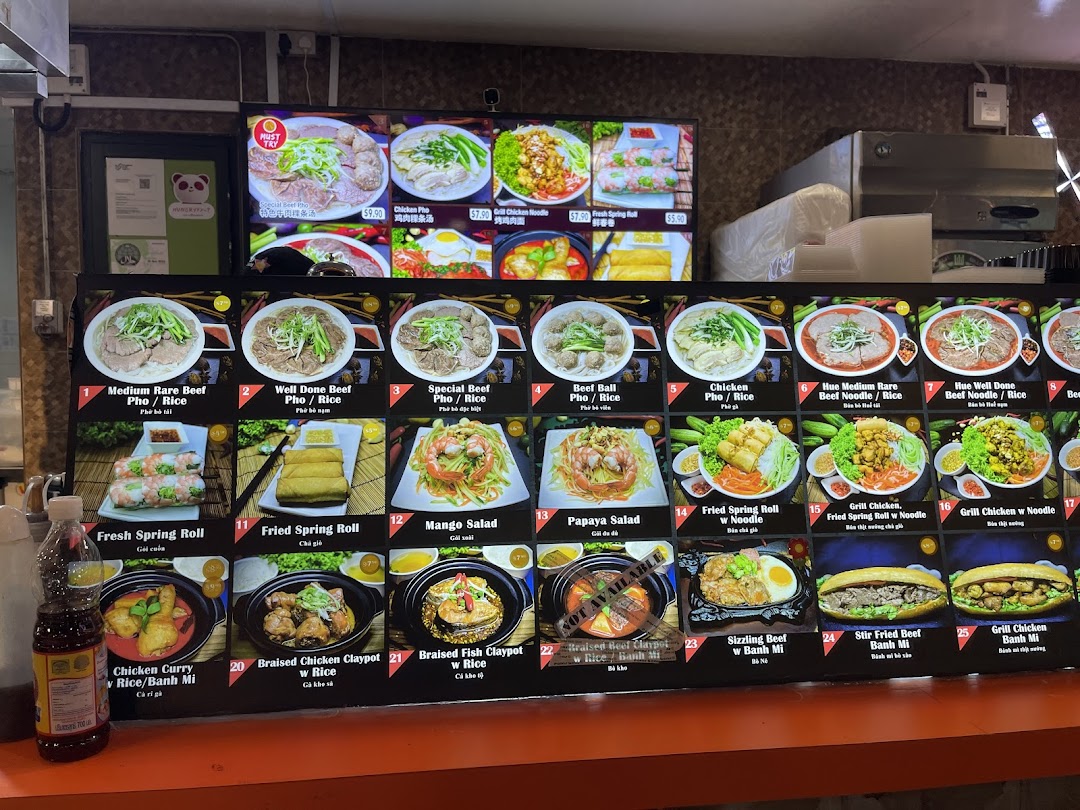 A digital menu board displaying various Vietnamese dishes with images and prices.
