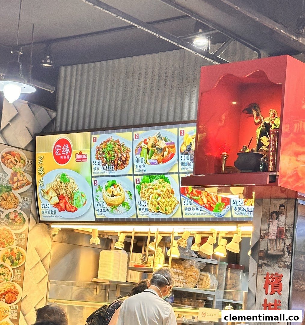 A food stall's menu board displaying various Asian dishes with prices and images, with customers queuing.