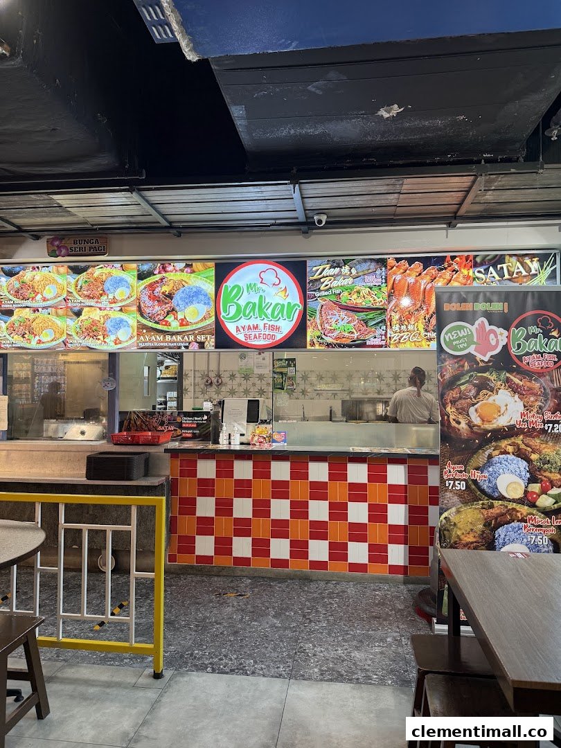 A vibrant food stall counter with illuminated menu displays showcasing various grilled dishes and sets.
