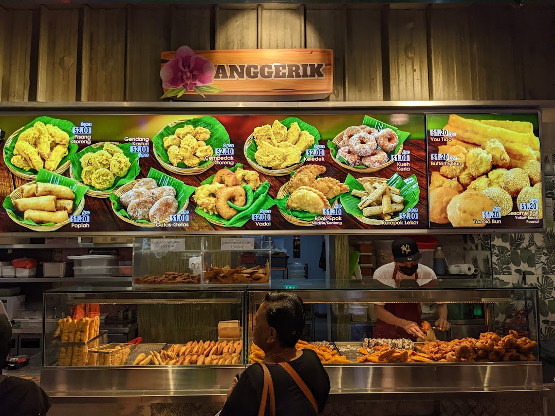 A vibrant display of traditional Malay fried snacks and pastries with prices at Anggerik stall.