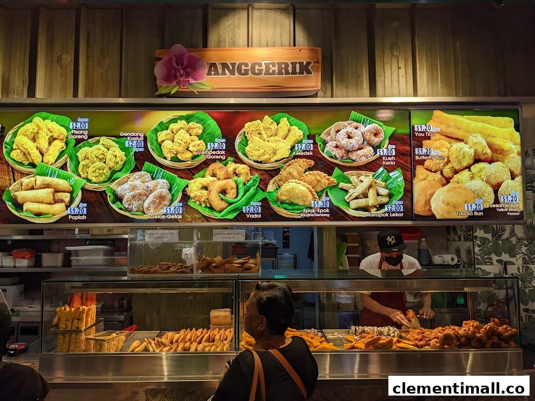 A vibrant display of traditional Malay fried snacks and pastries with prices at Anggerik stall.