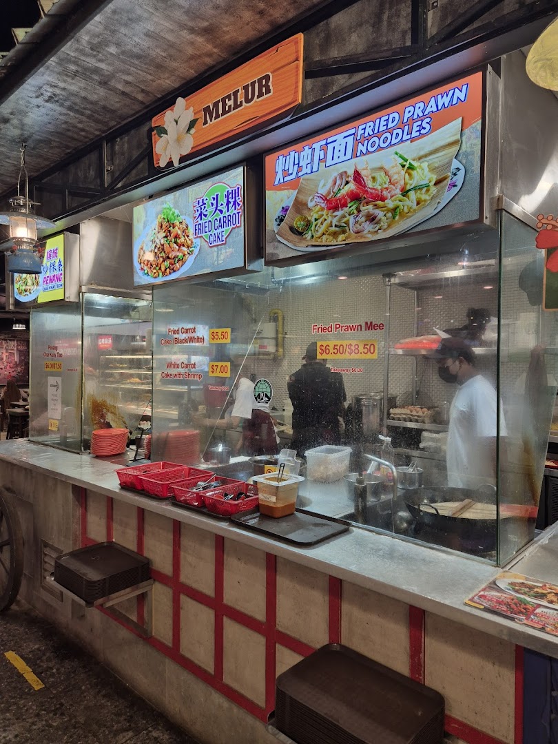 A bustling food stall counter at Boleh Boleh! Clementi Mall, showcasing popular local dishes and active food preparation.