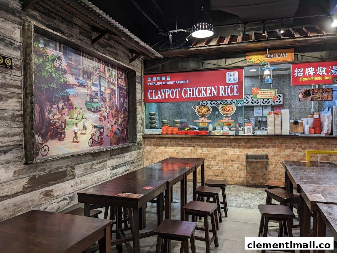 Interior view of a Claypot Chicken Rice stall featuring traditional decor, wooden tables, and a vibrant street mural.