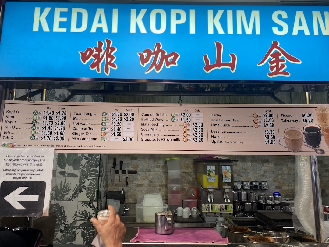 A menu board for drinks at Kedai Kopi Kim San, showing hot and cold beverage options.