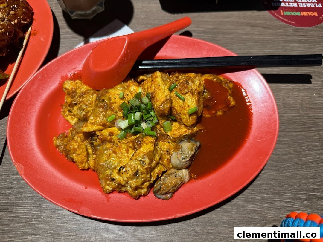 A vibrant red plate featuring a delicious oyster omelette garnished with spring onions, ready to be enjoyed.