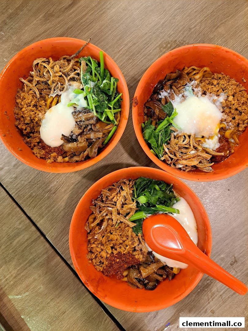 Three vibrant bowls of delicious noodles topped with minced meat, vegetables, anchovies, and a poached egg.