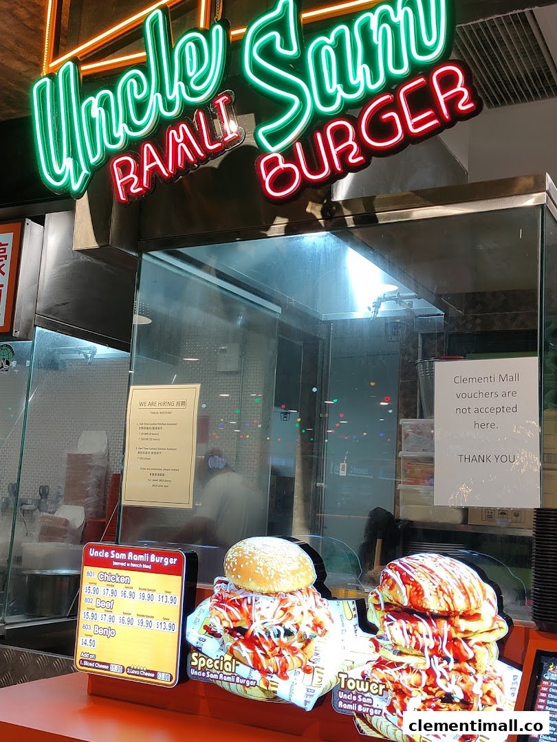 Front counter of Uncle Sam Ramli Burger with neon sign, menu board, and burger displays.