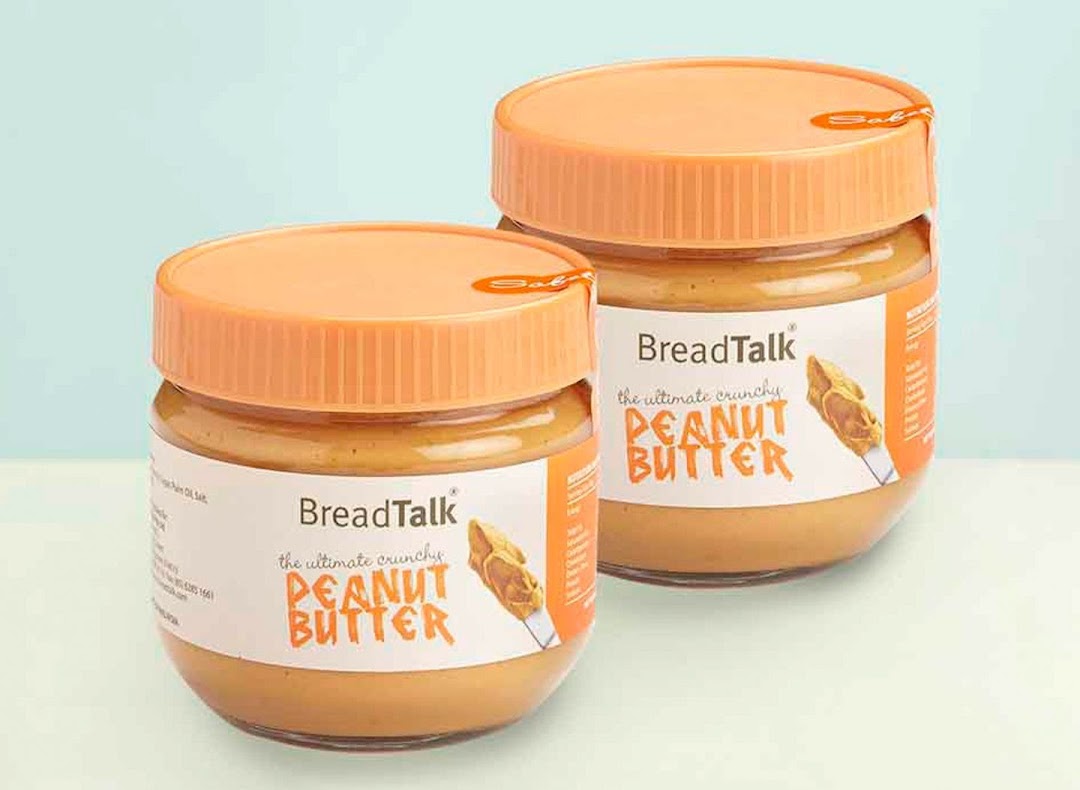 Two jars of BreadTalk 'The Ultimate Crunchy Peanut Butter' with orange lids are displayed.