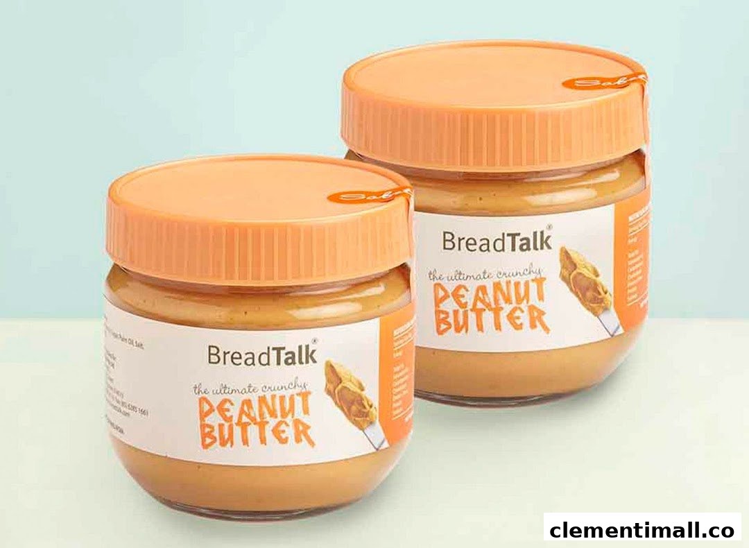 Two jars of BreadTalk 'The Ultimate Crunchy Peanut Butter' with orange lids are displayed.