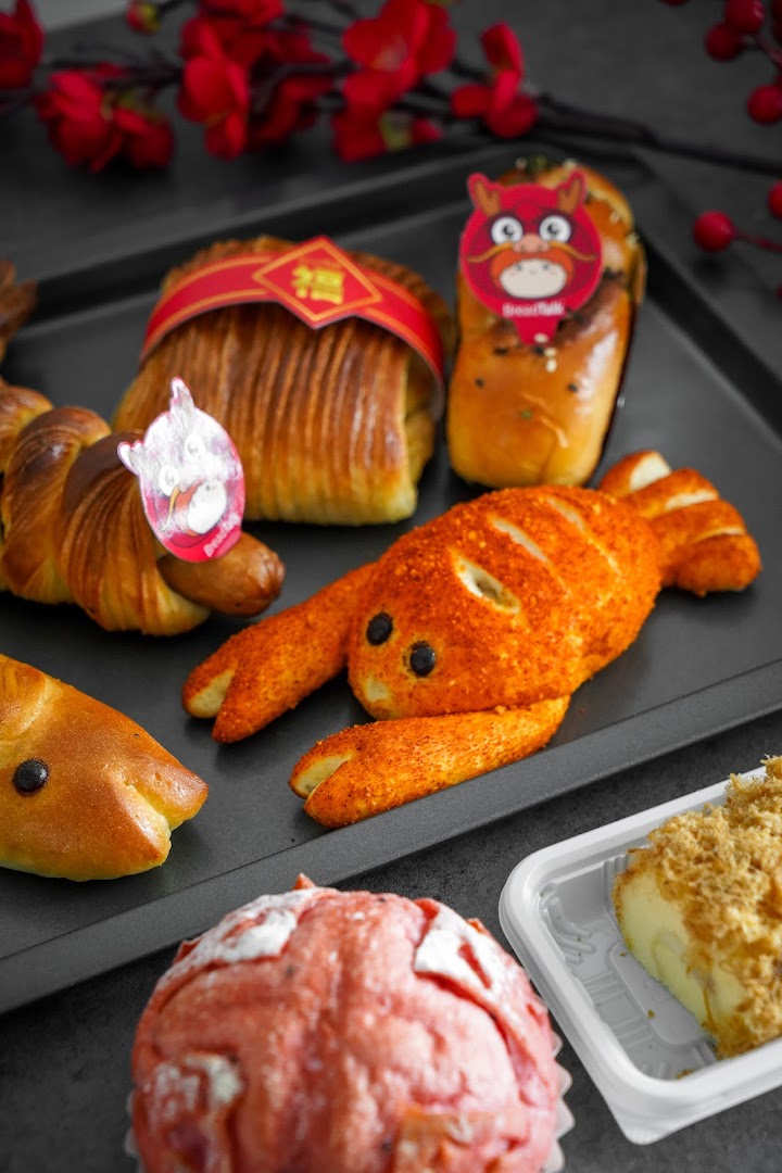 A vibrant display of freshly baked BreadTalk pastries, including animal-shaped breads and festive buns.