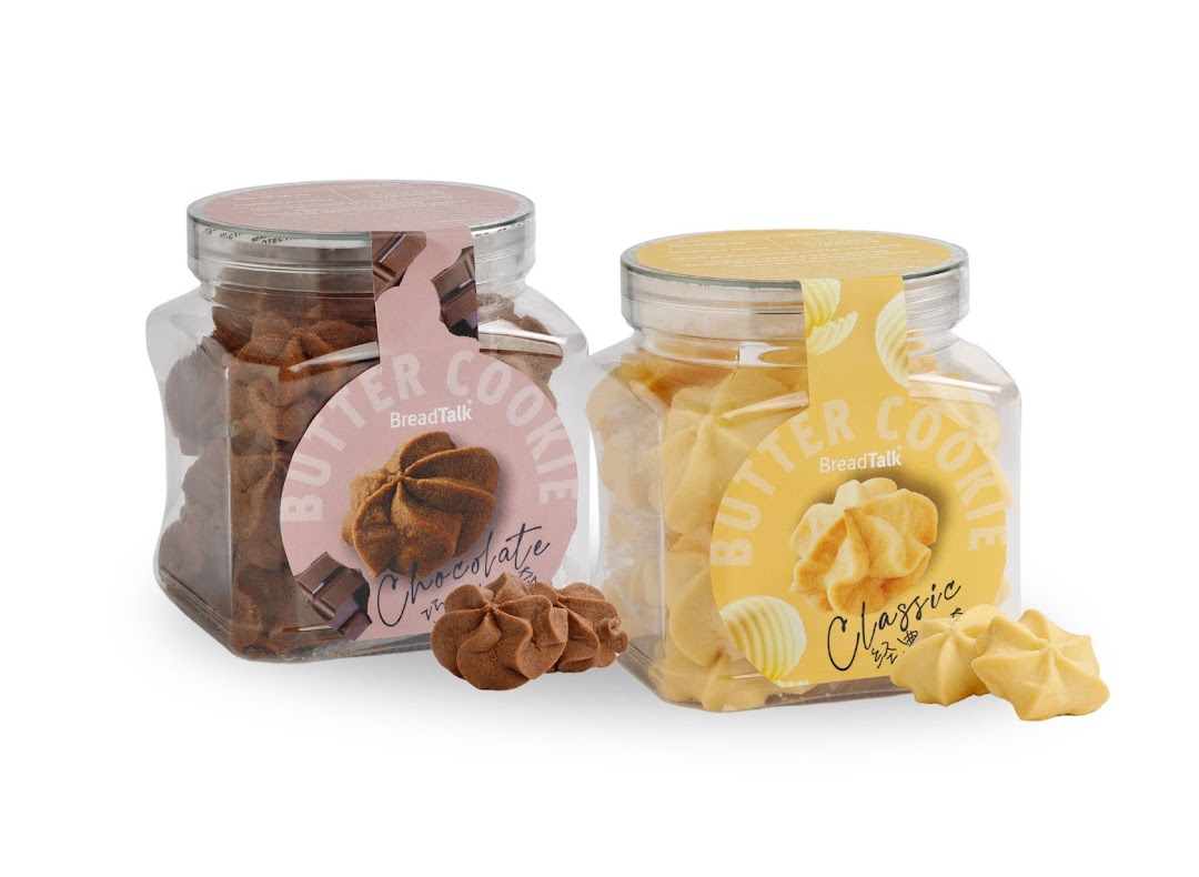 Two clear jars of BreadTalk butter cookies, chocolate and classic flavors, with loose cookies.