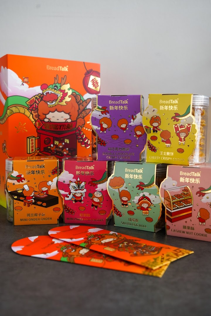 A vibrant display of BreadTalk's festive packaged cookies and pastries, including red envelopes, for a special occasion.