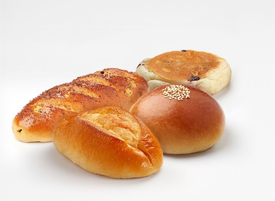 A variety of freshly baked breads and pastries from BreadTalk displayed on a clean white background.