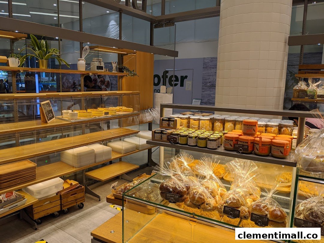 Interior view of BreadTalk bakery showcasing various baked goods, spreads, and display shelves.