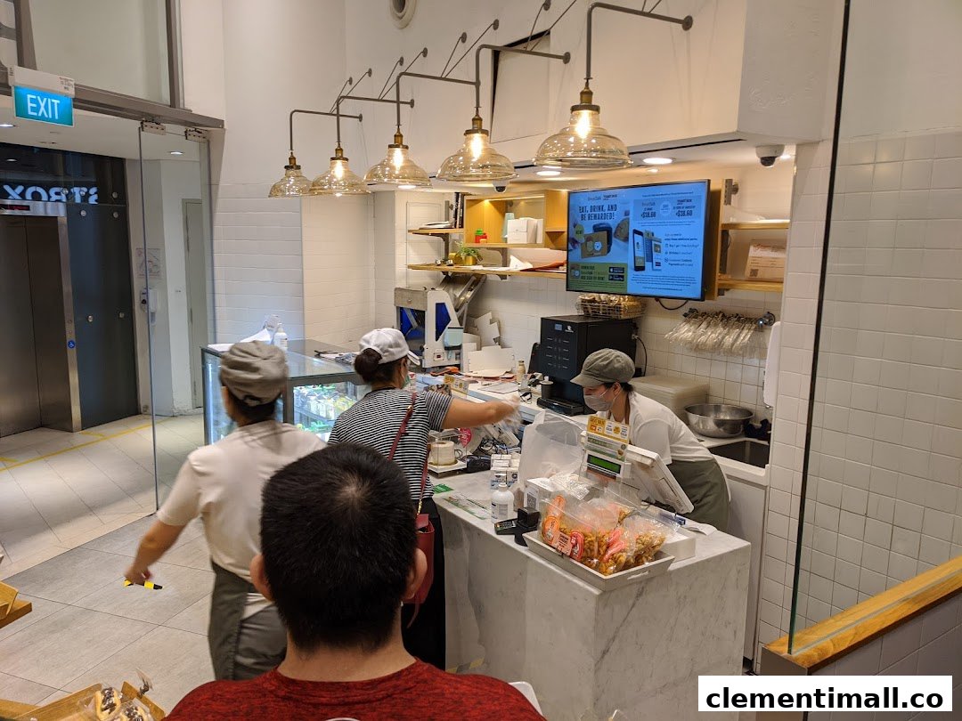 Interior view of BreadTalk with staff serving customers at the counter.