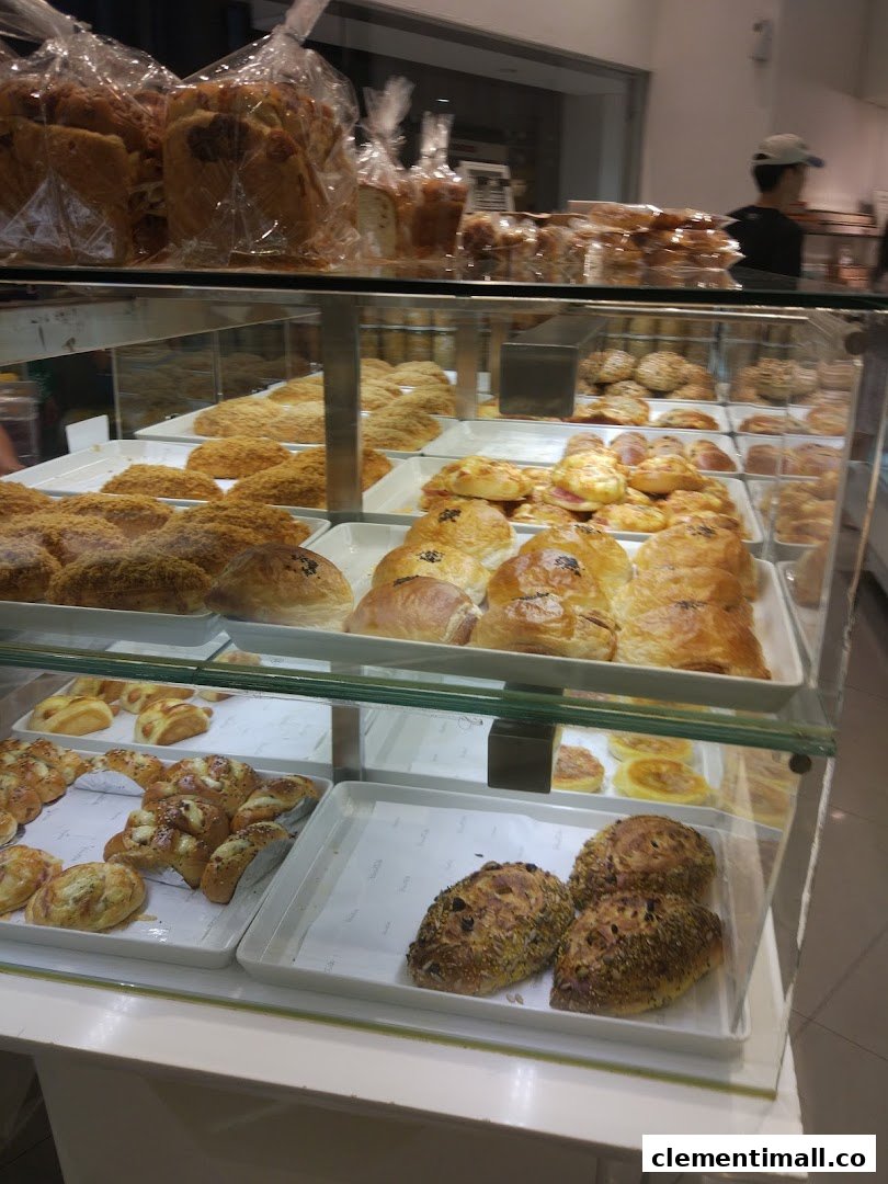 A vibrant display case showcasing a wide variety of freshly baked breads and pastries at BreadTalk.