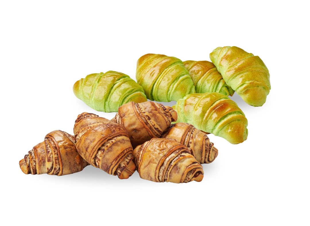 A vibrant collection of green and chocolate-swirl croissants, showcasing BreadTalk's diverse baked goods.