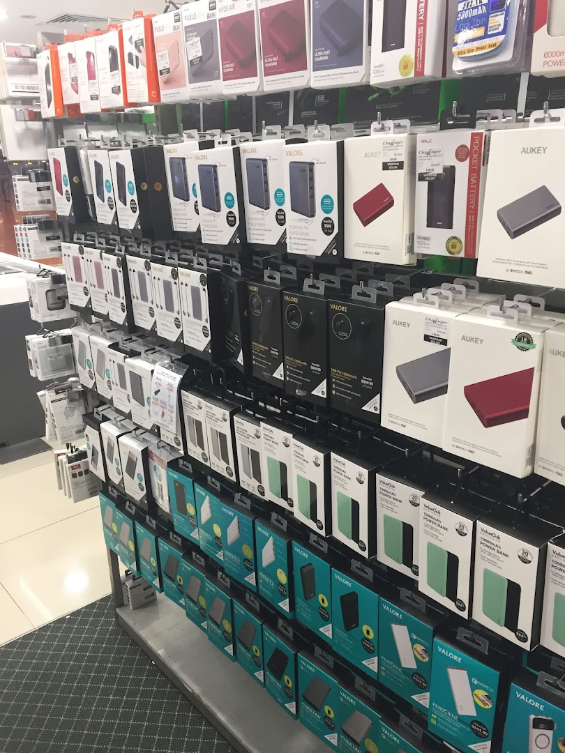 A retail display wall showcasing a wide range of power banks and mobile accessories.