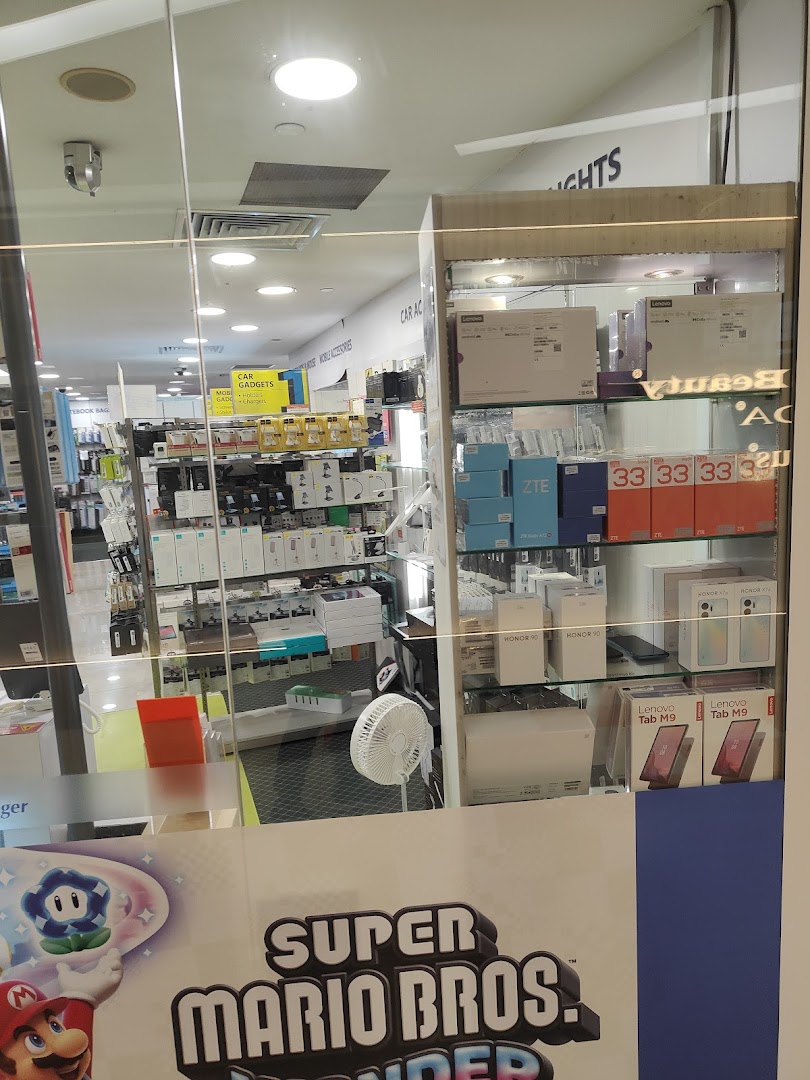 View into Challenger electronics store, showcasing mobile gadgets and accessories through its glass facade.