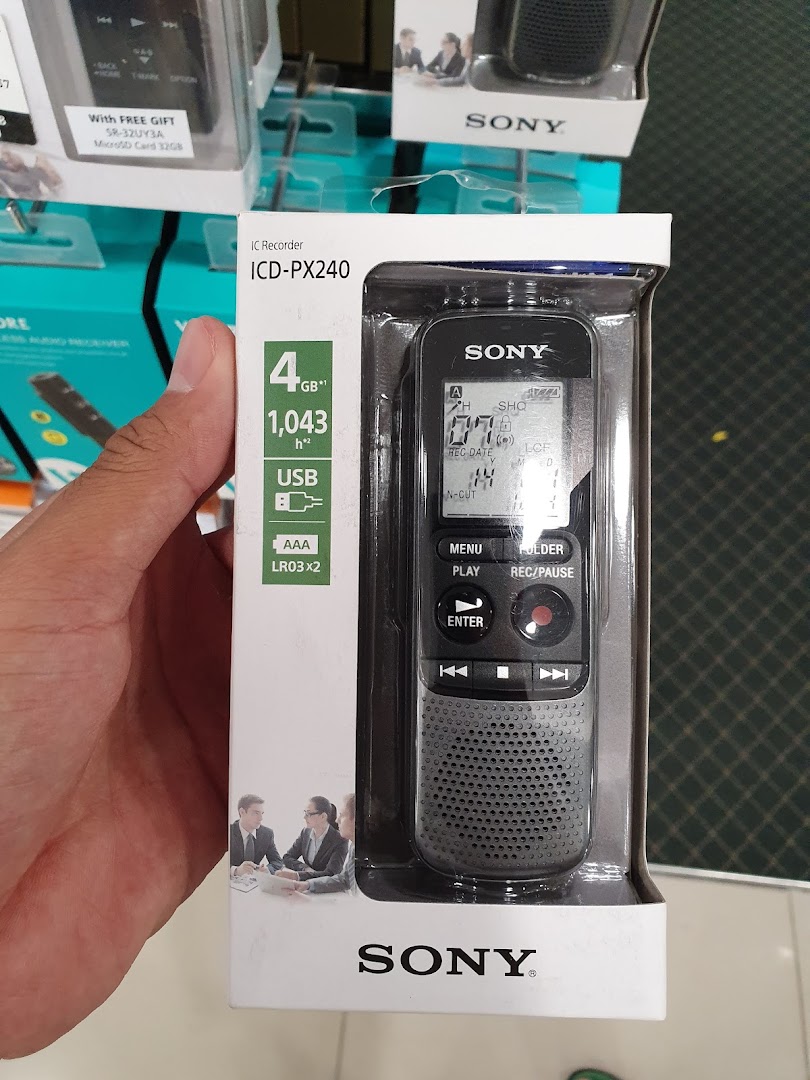 A hand holds a packaged Sony IC Recorder ICD-PX240 in a retail store.