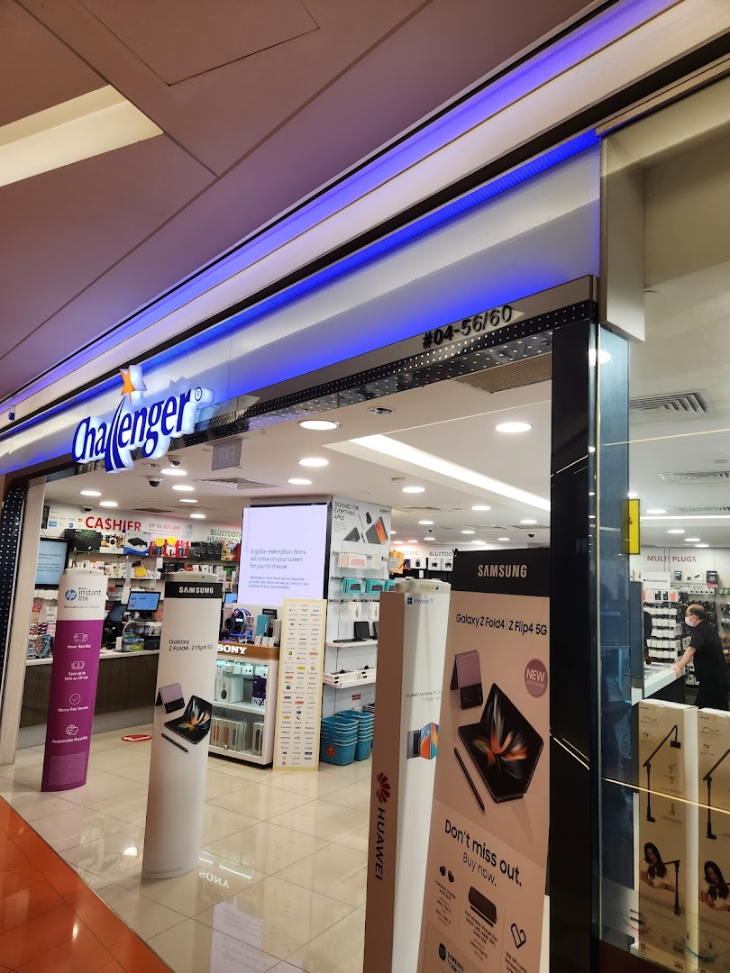 The brightly lit entrance of Challenger electronics store showcasing various tech product displays.