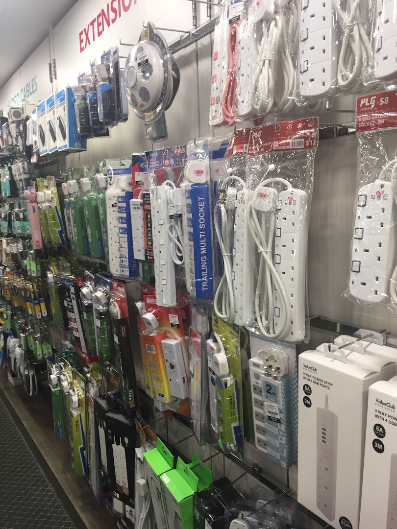 A retail display showcasing a wide range of power strips, extension cords, and electronic cables.