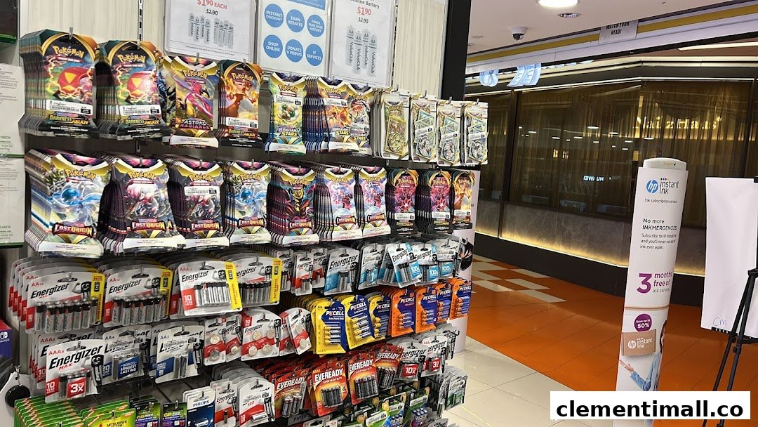 Shelves inside Challenger Clementi Mall displaying Pokémon trading card packs and various brands of batteries.