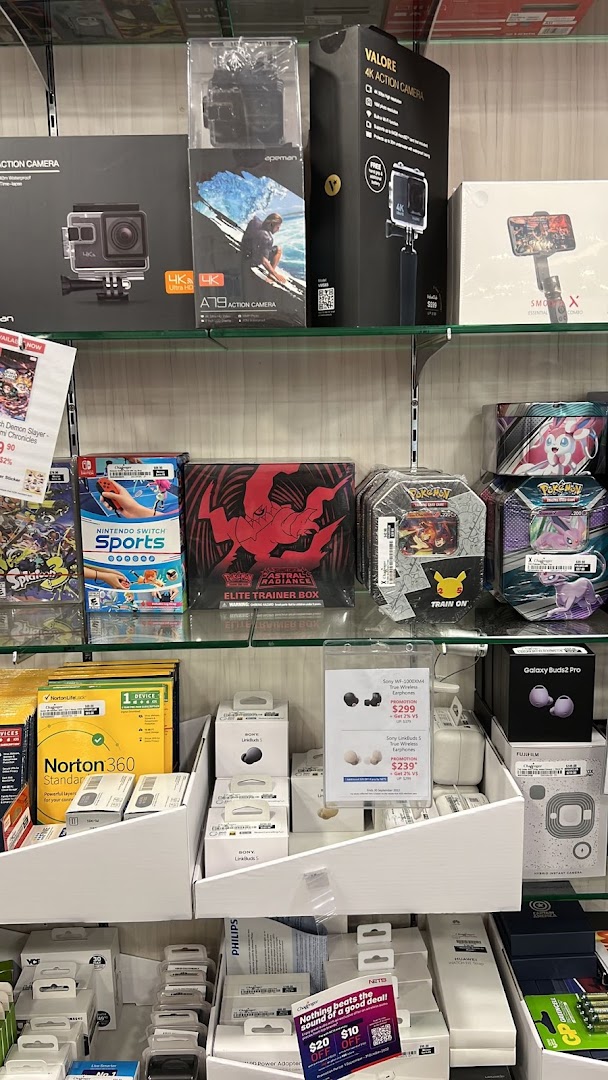 Shelves filled with electronics, gaming products, and accessories like action cameras, headphones, and software.