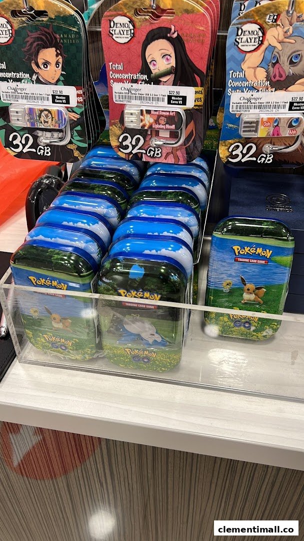 Close-up of anime-themed USB drives and Pokémon trading card game tins displayed at Challenger.