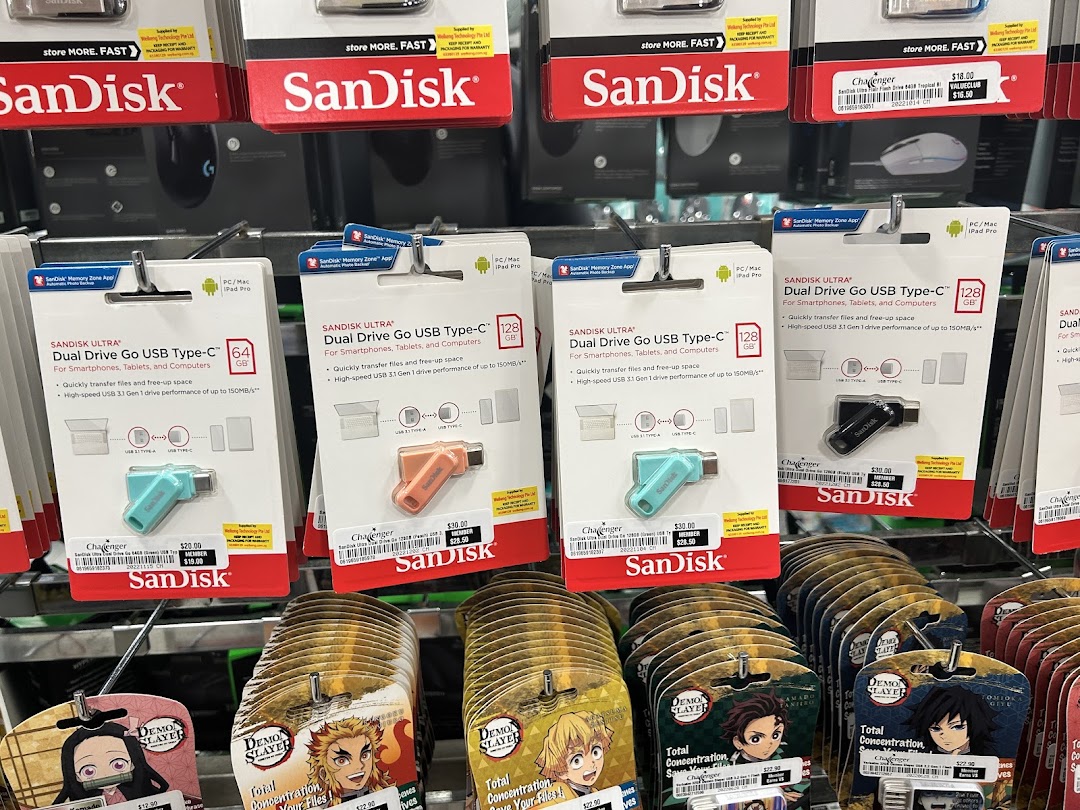 Close-up view of SanDisk USB drives and Demon Slayer merchandise displayed on shelves at Challenger.