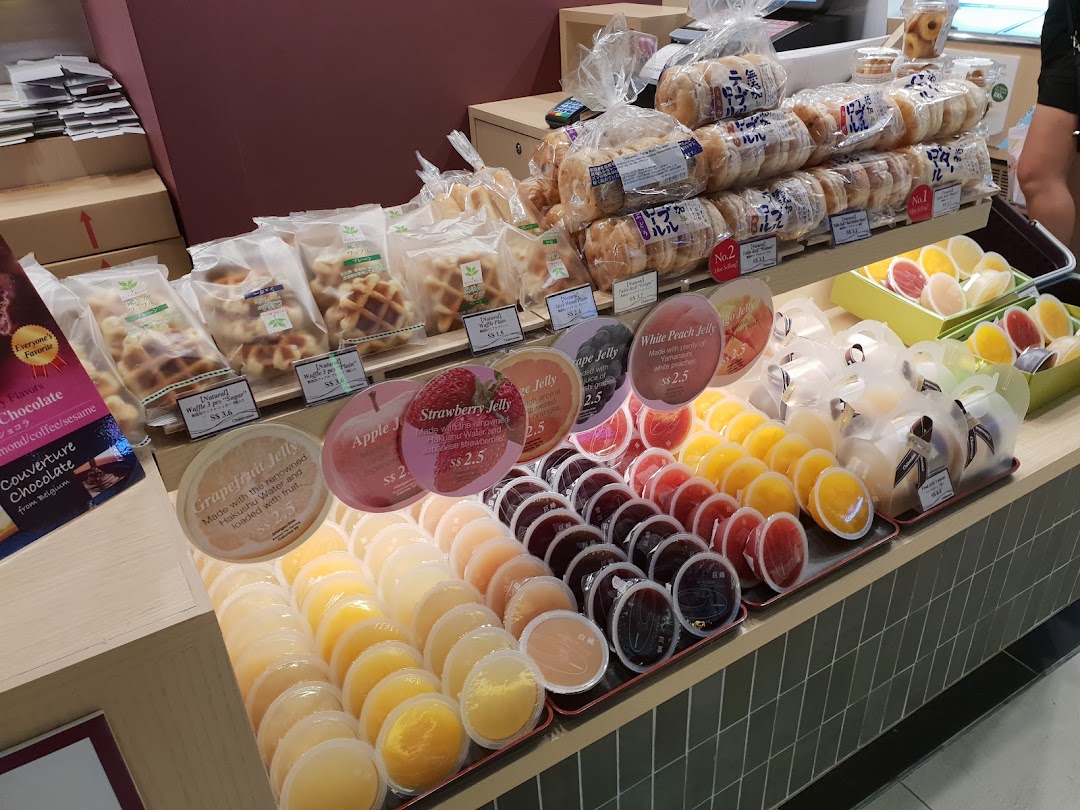 A vibrant display of Châteraisé's fresh fruit jellies, waffles, and baked goods in-store.