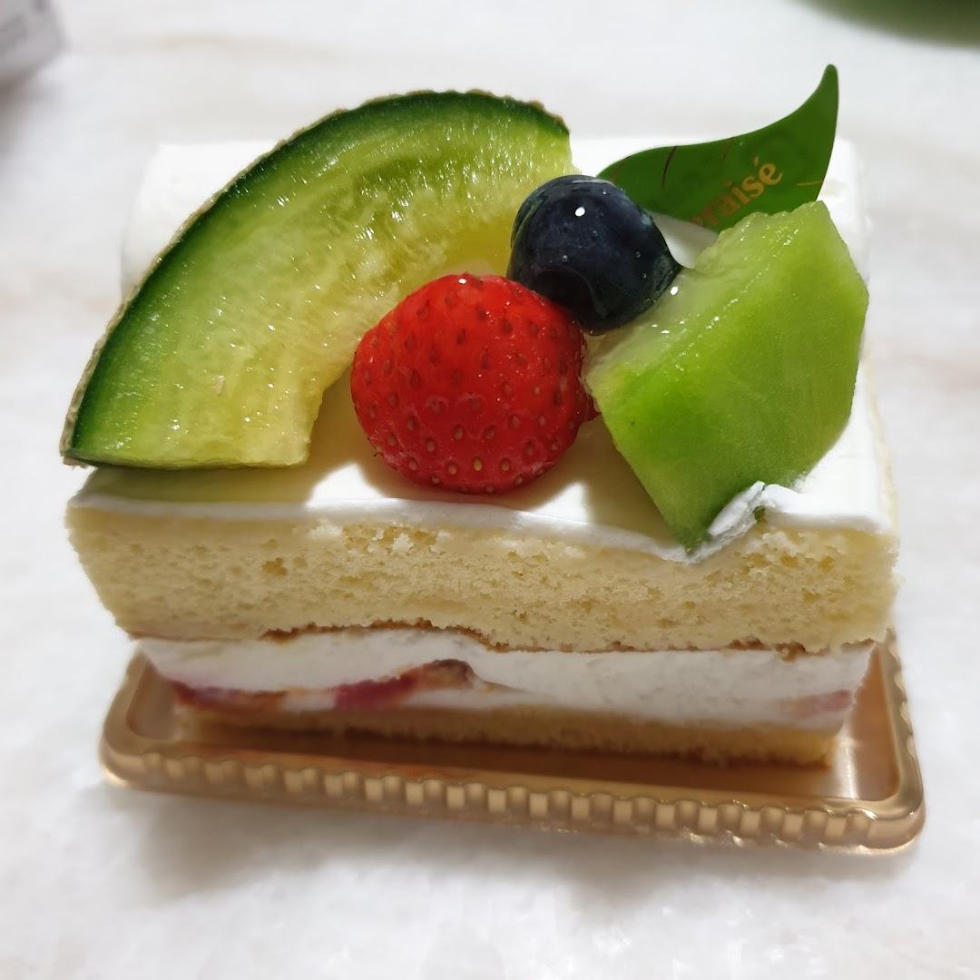 A delicious slice of fruit shortcake topped with fresh melon, strawberry, and blueberry.