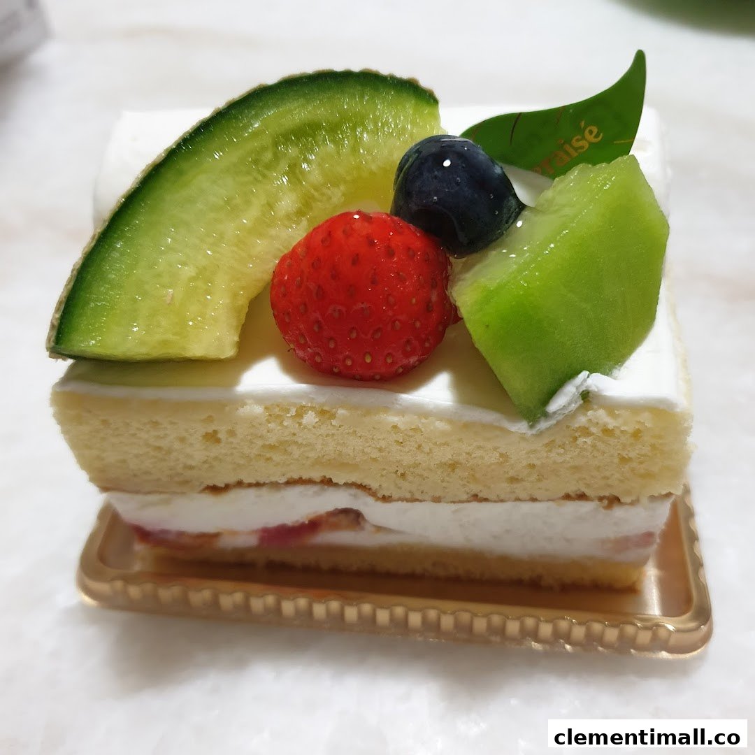 A delicious slice of fruit shortcake topped with fresh melon, strawberry, and blueberry.