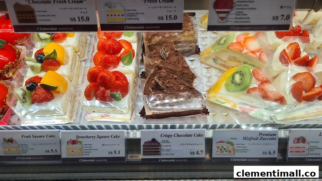 A vibrant display case showcasing various delicious cakes and desserts with price tags.