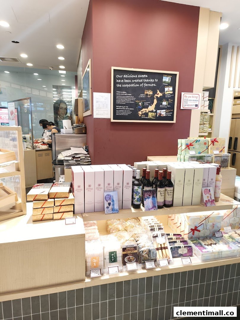 Interior view of Châteraisé, showcasing a display of Japanese sweets, beverages, and staff preparing items.