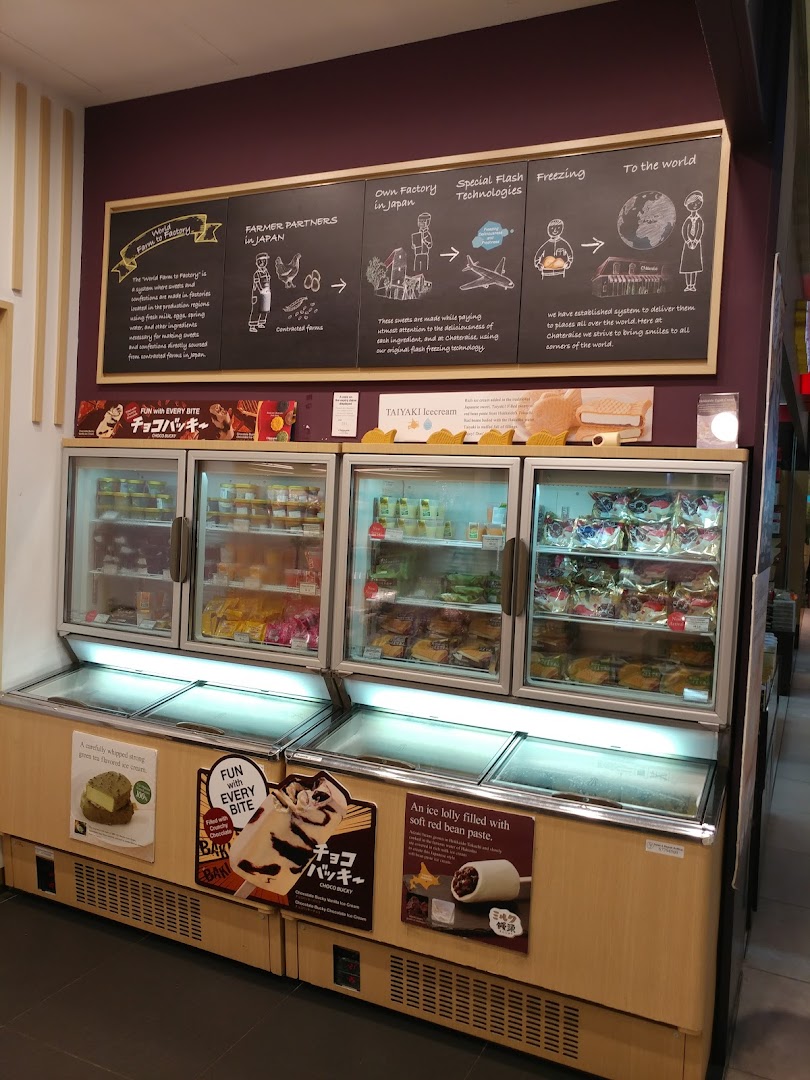 Display freezers filled with Japanese desserts and ice cream, with a wall graphic explaining Châteraisé's production process.