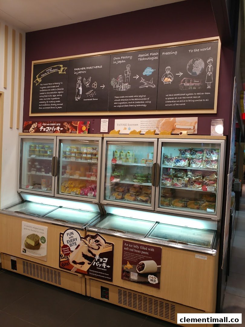 Display freezers filled with Japanese desserts and ice cream, with a wall graphic explaining Châteraisé's production process.