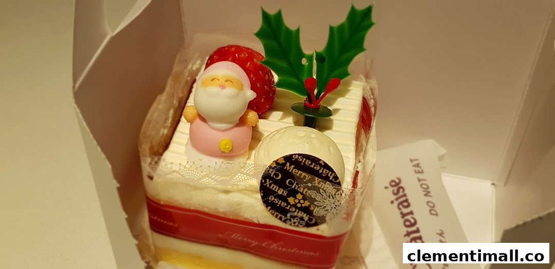 A festive Christmas cake from Châteraisé, adorned with Santa, strawberry, and holly decorations.