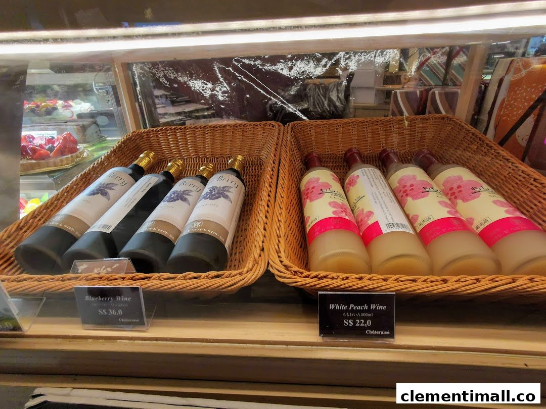 Bottles of Blueberry and White Peach Wine displayed in baskets with price tags at Châteraisé.