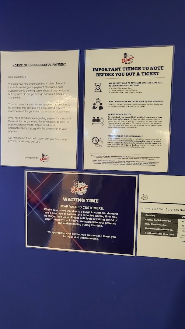 Informational signs and a partial service guide for Clippers Barber.