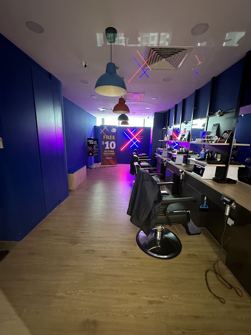 A modern barber shop interior with multiple styling stations and vibrant lighting.