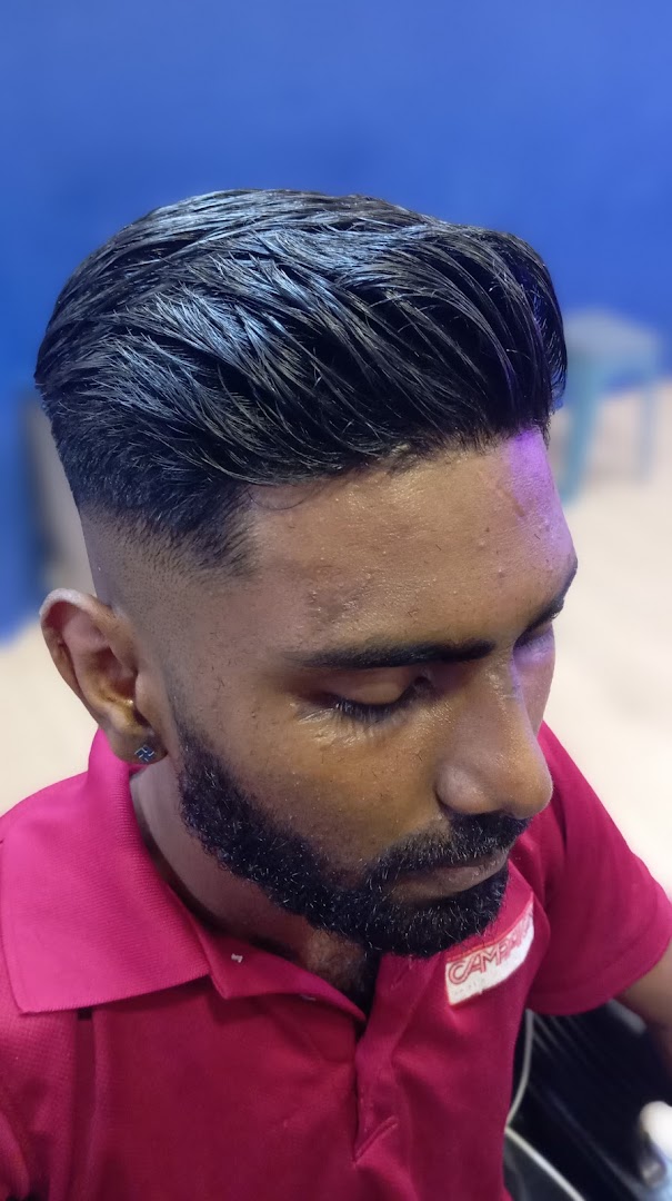 Close-up of a man with a fresh, stylish haircut and a well-groomed beard, showcasing barber services.