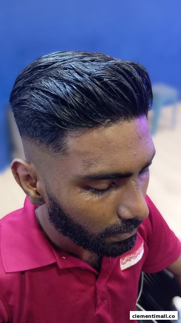 Close-up of a man with a fresh, stylish haircut and a well-groomed beard, showcasing barber services.