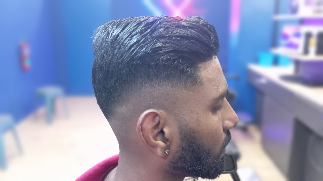 Close-up of a man with a fresh, stylish fade haircut, showcasing the barber's skill.