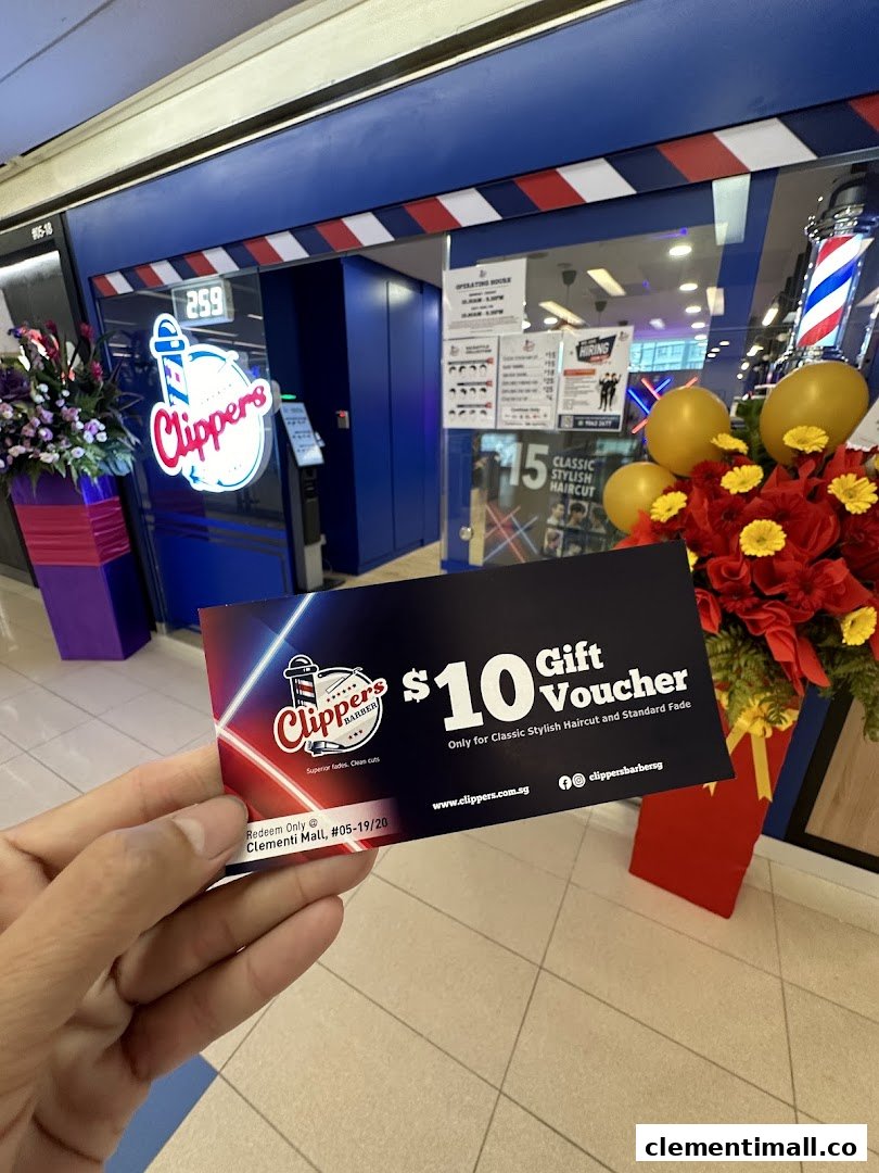 A hand holds a $10 gift voucher in front of Clippers Barber shop entrance at Clementi Mall.