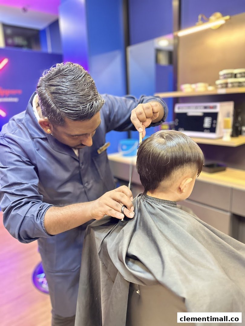 A skilled barber meticulously cutting a child's hair inside Clippers Barber.