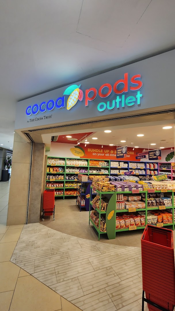 The vibrant entrance of Cocoa Pods by The Cocoa Trees outlet, showcasing a wide array of confectionery.